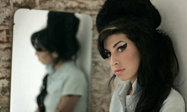 FILE - In this Feb. 16, 2007 file photo, British singer Amy Winehouse poses for photographs after being interviewed by The Associated Press at a studio in north London. Amy Winehouse, the beehived soul-jazz diva whose self-destructive habits overshadowed a distinctive musical talent, was found dead Saturday in her London home, police said. She was 27. (AP Photo/Matt Dunham, File)