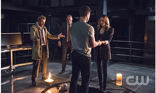 Arrow -- "Haunted" -- Image AR404B_0027b.jpg -- Pictured (L-R) Matt Ryan as Constantine, Paul Blackthorne as Detective Quentin Lance, Stephen Amell as Oliver Queen and Katie Cassidy as Laurel Lance -- Photo: Cate Cameron/ The CW -- © 2015 The CW Network, LLC. All Rights Reserved.