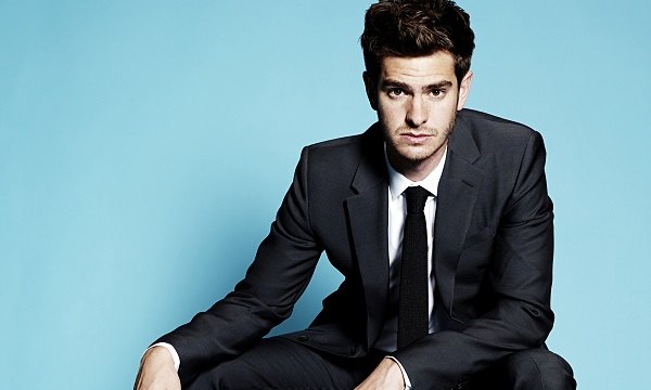 Andrew Garfield, looking serious, in a suit